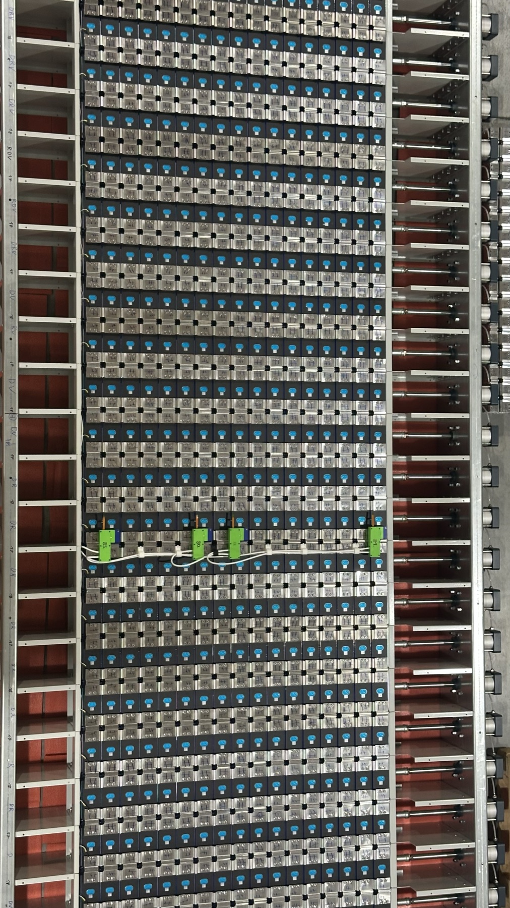 Looking down into the Energy compartment: rows of cells between inter-cell heat exchangers, with compression hardware along the sides.